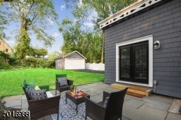Kick back and relax in this secluded bluestone patio overlooking a lushly landscaped backyard.