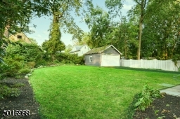 There is lots of space to hang out in this lushly landscaped backyard with bluestone patio, detached garage and newly paved driveway.