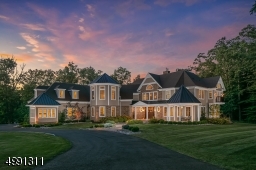HardiPlank and stone envelop the homes long horizontal lines complemented with tall gables, winsome turret, and columned porch with gazebo. Thirteen rooms,each with its own architectural scheme, are harmoniously contained within the approx. 7000 sq. Ft.