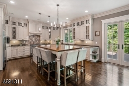 Today's favored white-hued cabinetry keeps things bright. Appliances include Wolf 6-burner range and microwave, Sub-Zero refrigerator/freezer with ice/water feature, Miele dishwasher.