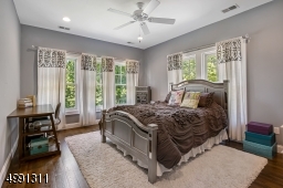 Views to the rear and side grounds are seen from this window-filled room including walk-in custom closet and bath.