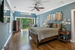 Double door entry. Walk-in custom closet. Palladiun window over French doors opening to Juliet Balcony and view to woodlands.