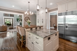 Extraordinary top-of the line granite. At the center island a granite prep area joins a raised butcher-block dining table with seating for four. Kitchen is open to the Great Room.