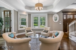 Open to the foyer, the living room offers arrivals unimpeded welcome. An octagonal tray ceiling is overhead.