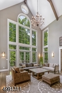 A Palladium window virtually rises to the 30-foot height of the beamed cathedral ceiling. Enjoy this front-row seat to nature's seasonal changes. French doors open to the maintenance-free deck.