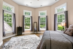 Located on the second level of the turret, transoms top the multiple windows. Double-door closet. Located across from hall bath.