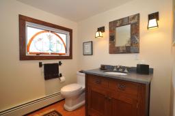Enhanced with a custom stained glass window, and Prairie-style vanity