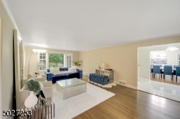 Formal living room with gorgeous windows offering sun kissed views of the yard.