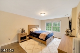 One of 5 bedrooms with hardwood flooring and walk in closet.