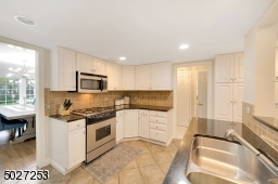 Kitchen with granite counter-tops and stainless steel appliances.