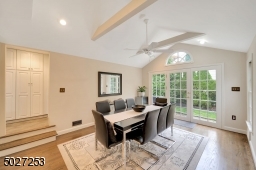 Cathedral ceilings and french doors make for a bright and peaceful casual dining space.