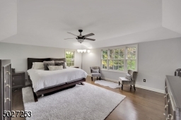 Large master bedroom with hardwood flooring, full bath and walk in closet.