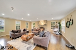 Cozy family room with wood burning fireplace and stone surround.