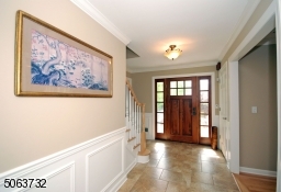 Area. Solid Wood Door. Crown Moldings and Beautiful Wood Trim.