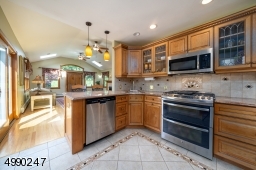 Gorgeous custom kitchen with overhead lighting and island.