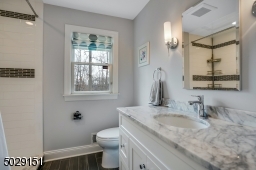 First floor full bathroom adjacent to a bedroom intended as private quarters for guests.