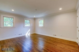 Bright, corner bedroom, one of 3 bedrooms on this level - features attractive en suite bath, refinished wood floor, recessed lighting, two closets. All bedrooms are wired for cable.