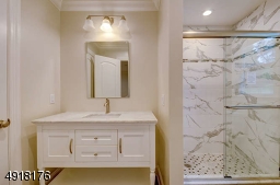 Tiled floor, beautiful stall shower features decorative tile and corner niches.  Linen closet.