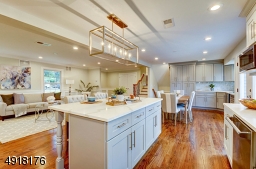 Truly a chef's delight! Beautiful wood cabinetry and center island with quartz countertops, marble backsplash.