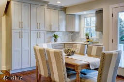 Custom designed and true delight! Ample built-in floor to ceiling cabinetry. Good counter space. Zepher 2-zone wine cooler & wet bar. Allows morning to night experience! Great as breakfast nook or for evening entertaining!
