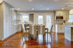 Spacious dining area is bright from the French doors which allow natural sunlight to flow in! It also allows access to the Deck and overlooks the large, deep backyard.