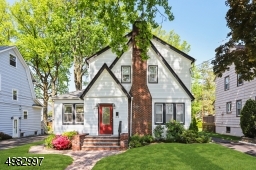 Beautiful curb appeal surrounds this Storybook Tudor
