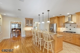 view of the kitchen opens to the Formal Dining Room and den