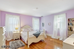 spacious bedroom, three windows, hardwood floor, closet
