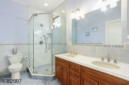 features two sinks, soaking tub, stall shower
