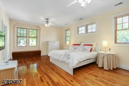 Large master bedroom boasts hardwood floors, high ceilings, walk- in closet
