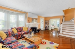 spacious living room features hardwood floors with ribbon in-lay