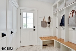 Conveniently located 1st floor laundry (behind closet doors) and custom mudroom upon entry from charming side porch