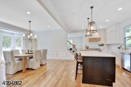 Bright, open concept kitchen/dining room with bay window