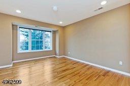 Spacious master with hardwood floors, a walk-in closet and full bath with double vanity
