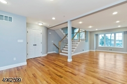 Spacious with plenty of sunlight and hardwood floors. This level includes a powder room, coat closet, dining room and eat-kitchen with breakfast bar and balcony
