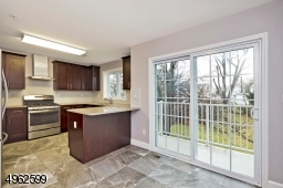 Granite counter tops, custom cabinets, stainless steel appliances, a breakfast bar and sliders to the balcony overlooking the courtyard.