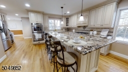 Huge Center Island with Cream Kitchen - Stainless Steel Appliances