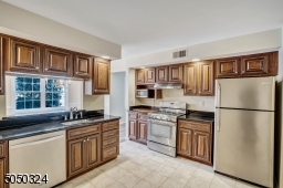Rich wood cabinetry matched with stainless steel appliances make this the perfect kitchen for any cook!