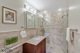 Gleaming marble and frameless shower enclosures.