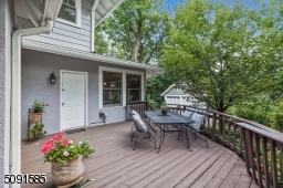 Newly finished wood deck overlooks the lush backyard.