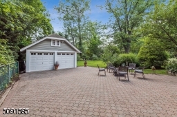 Two car detached garage with loft and extra storage.