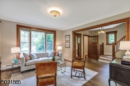 Spacious Living Room with gleaming hardwood floors and bay window.