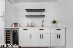 Wet Bar with tons of storage, counter space and a wine refrigerator leads from dining room into gorgeous chef's kitchen!