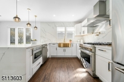 Stainless steel appliances, gold accents and white quartz everywhere makes this your dream kitchen!