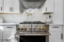 Gorgeous Jenn-Air gas range with gold pot-filler!