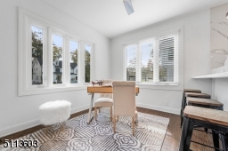 Beautiful gourmet kitchen overlooks breakfast bar into cozy den that is perfect for a home office, a homework space, or a place to snuggle up and watch TV.