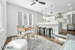 Beautiful gourmet kitchen overlooks breakfast bar into cozy den that is perfect for a home office, a homework space, or a place to snuggle up and watch TV.