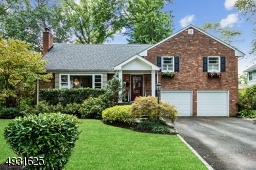Portico, window boxes, paver walk ways & professional landscaping enhance the curb appeal of this charming Northside Cranford Home in the Brookside School District.