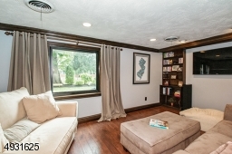 Grade Level Family Room boasts a picture window, built--in bookcases, an adjacent powder room and a door to the yard.