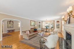 Entertain in style in this front to back sun drenched living room with fireplace & windows on either side